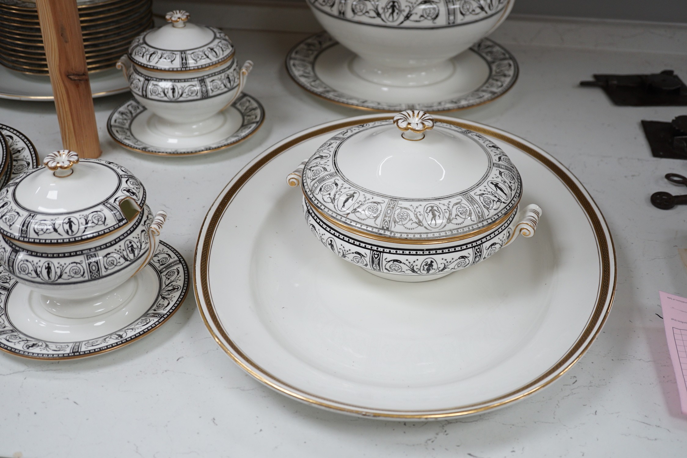 A Victorian Wedgwood part dinner service, with black printed classical borders, together with two Minton meat dishes and a Wedgwood gilt bordered coffee service.